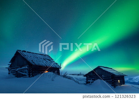 Old wooden cabins in snowy mountains under incredible Northern lights Old wooden cabins in snowy mountains under incredible Northern lights 121326323