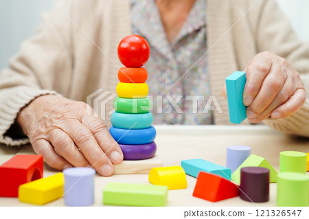 Asian elderly woman playing game. 121326547