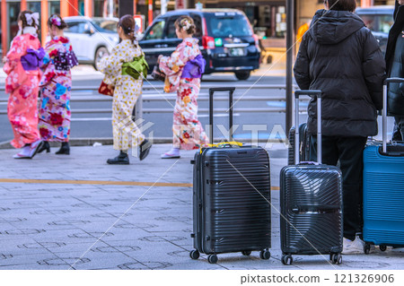 Tokyo cityscape in Japan. End of the year. Inbound tourism continues... Tourists with suitcases are seen one after another in front of Asakusa Station and at Azumabashi intersection... Tokyo cityscape in Japan. End of the year. Inbound tourism continues... Tourists with suitcases are seen one after another in front of Asakusa Station and at Azumabashi intersection... 121326906