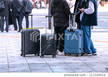 Tokyo cityscape in Japan. End of the year. Inbound tourism continues... Tourists with suitcases are seen one after another in front of Asakusa Station and at Azumabashi intersection... 121326914