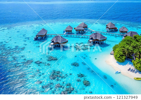 Luxurious overwater bungalows are connected by wooden walkways Luxurious overwater bungalows are connected by wooden walkways 121327949