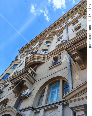 The facade of a classic building showing cracks and uneven modifications. This image emphasizes the consequences of neglect and unregulated urban growth on heritage structures. The facade of a classic building showing cracks and uneven modifications. This image emphasizes the consequences of neglect and unregulated urban growth on heritage structures. 121328175