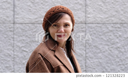 A portrait of a woman enjoying a crisp day, her relaxed demeanor complementing the cozy outdoor vibe. A portrait of a woman enjoying a crisp day, her relaxed demeanor complementing the cozy outdoor vibe. 121328223