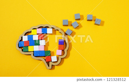 Brain made of colorful blocks breaking into gray pieces. Mental health challenges and cognitive decline. 121328512