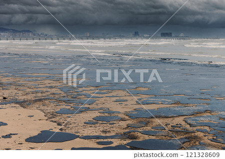 Oil leaked in ocean coastline after a tanker wreck. Oil fuel polluted and destroy beach. Ecological crisis 121328609