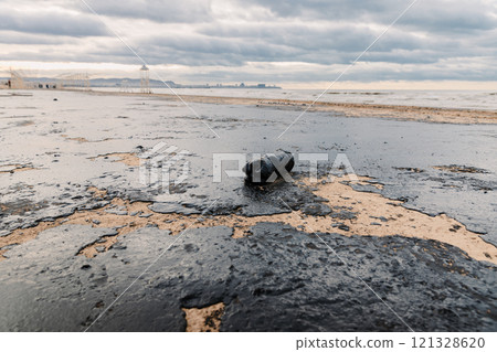 Oil in sea coastline after a tanker wreck. The beach is polluted with fuel oil Oil in sea coastline after a tanker wreck. The beach is polluted with fuel oil 121328620