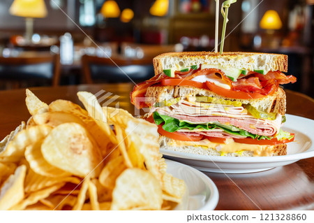 Club sandwich with layers of turkey and ham with bacon with lettuce and mayonnaise.AI Generative. 121328860