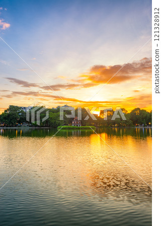 Hoan Kiem Lake ( Ho Guom) or Sword lake in the center of Hanoi in cinematic sunset sky. Hoan Kiem Lake ( Ho Guom) or Sword lake in the center of Hanoi in cinematic sunset sky. 121328912