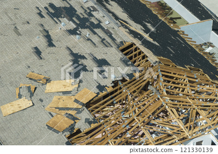Hurricane Ian destroyed house roof and walls in Florida residential area. Natural disaster and its consequences Hurricane Ian destroyed house roof and walls in Florida residential area. Natural disaster and its consequences 121330139