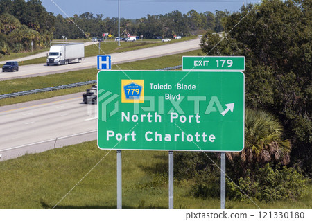 Highway interchange exit sign with direction to North Port and Port Charlotte in Florida. Interstate freeway travel in USA Highway interchange exit sign with direction to North Port and Port Charlotte in Florida. Interstate freeway travel in USA 121330180