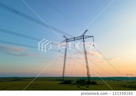 High voltage towers with electric power lines at sunset. 121330183