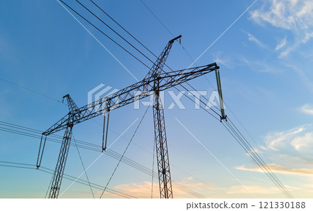 High voltage tower with electric power lines at sunset. Transmission of electricity High voltage tower with electric power lines at sunset. Transmission of electricity 121330188