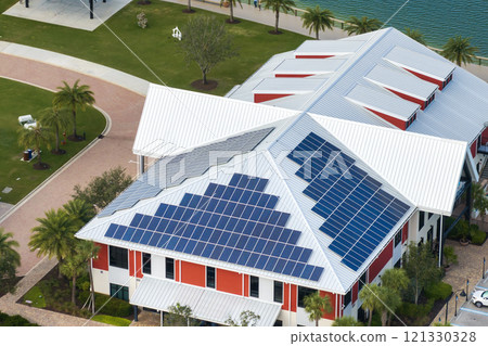Florida office building with solar roof. Blue photovoltaic panels for producing clean ecological electric energy. Investing in renewable electricity concept 121330328