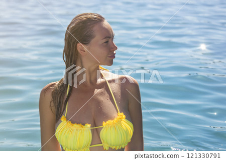 Summer holidays. Sexy wet girl in a bikini swims in the sea. resting on the sea coast. Summer holidays. Sexy wet girl in a bikini swims in the sea. resting on the sea coast. 121330791
