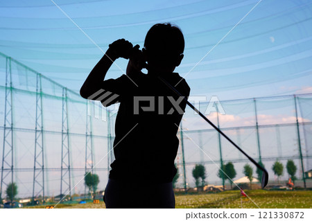 Boy practicing golf 121330872
