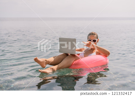 Freelance close up woman hands writing on computer. Well looking middle aged woman typing on laptop keyboard outdoors with beautiful sea view. 121332417