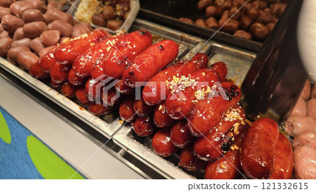 Delicious, brightly colored sausages stacked in an appealing display at a Thai food market festival Delicious, brightly colored sausages stacked in an appealing display at a Thai food market festival 121332615