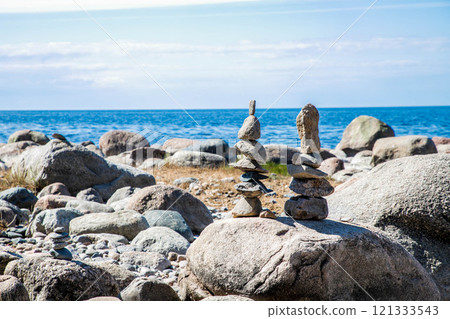 two stone towers standing on a large stone two stone towers standing on a large stone 121333543