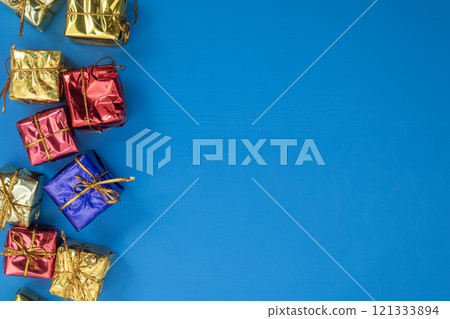 Colorful gift boxes on blue background with copy space 121333894