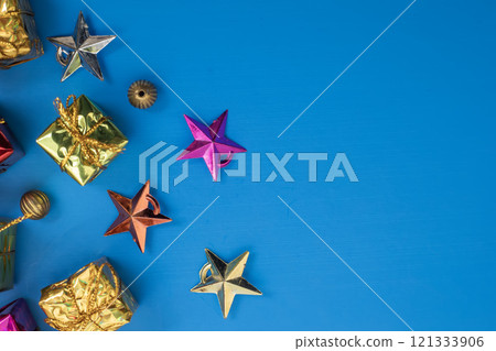 Colorful gift boxes and stars with gold decorations on a blue background 121333906