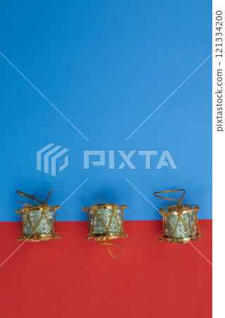 Traditional Christmas decorative drums on a bright blue and red background 121334200