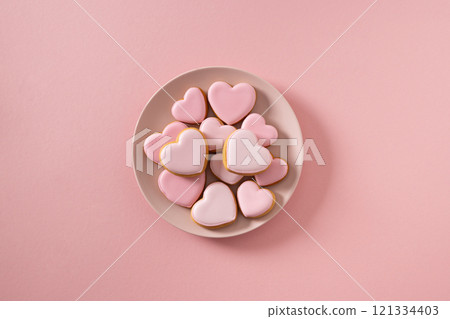 Valentine's Day heart shaped pink glazed cookies in pink plate on pink background. View from above. Love concept. 121334403