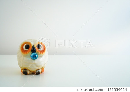 A cute white owl made of Shigaraki ware on a white background. Copy space 121334624