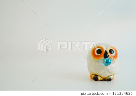 A cute white owl made of Shigaraki ware on a white background. Copy space 121334625