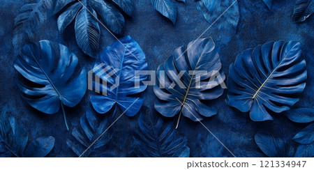 Tropical leaves in varying shades of blue display their textures against a dark backdrop, creating an artistic botanical arrangement Tropical leaves in varying shades of blue display their textures against a dark backdrop, creating an artistic botanical arrangement 121334947