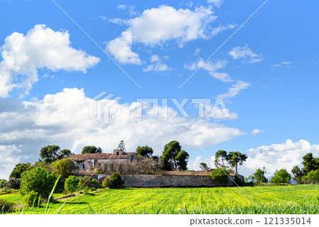 Old abandoned stone country house in Catalonia, surrounded by a meadow and trees 121335014