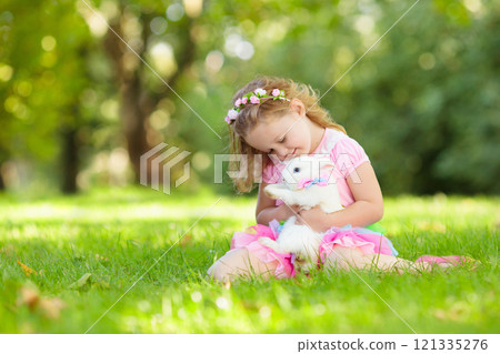 Kids playing with pet rabbit Kids playing with pet rabbit 121335276