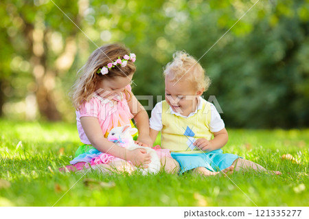 Kids playing with pet rabbit 121335277