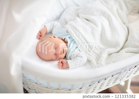 Cute newborn baby in white bed 121335382