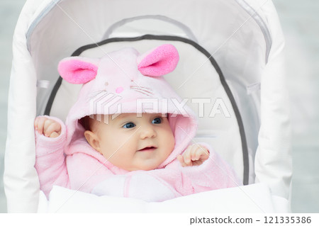 Baby girl in stroller in autumn park Baby girl in stroller in autumn park 121335386