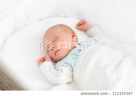 Cute newborn baby in white bed 121335387