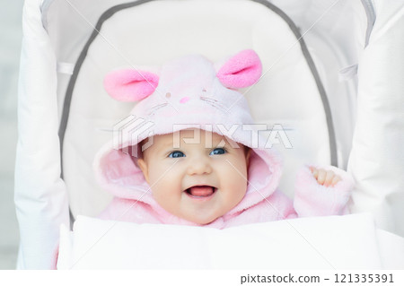 Baby girl in stroller in autumn park Baby girl in stroller in autumn park 121335391