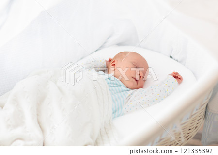 Cute newborn baby in white bed 121335392