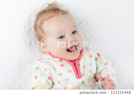 Little baby girl on colorful blanket Little baby girl on colorful blanket 121335448