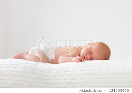 Little baby on white bed Little baby on white bed 121335460