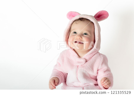 Little baby girl on white bed 121335529