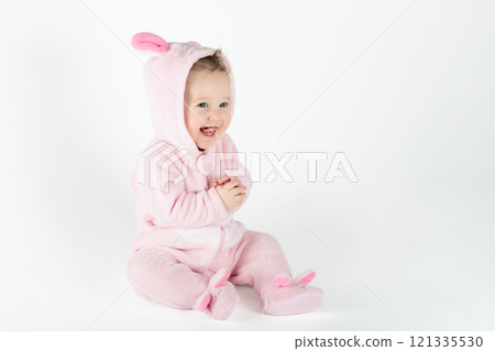 Little baby girl on white bed Little baby girl on white bed 121335530