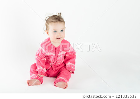 Little baby girl on white bed 121335532