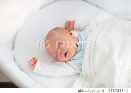 Cute newborn baby in white bed Cute newborn baby in white bed 121335544