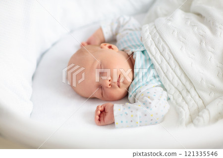 Cute newborn baby in white bed Cute newborn baby in white bed 121335546