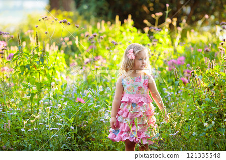 Little girl in flower garden 121335548