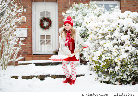 Child shoveling winter snow. Kids clear driveway. Child shoveling winter snow. Kids clear driveway. 121335553