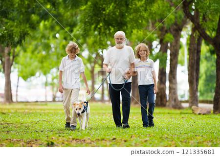 Senior man and grandchildren walking dog. Senior man and grandchildren walking dog. 121335681