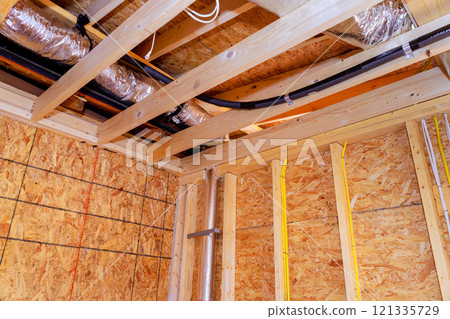 Construction on installing wood framing ductwork in new home under development during construction new house 121335729