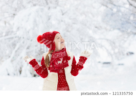 Child playing in snow on Christmas. Kids in winter Child playing in snow on Christmas. Kids in winter 121335750