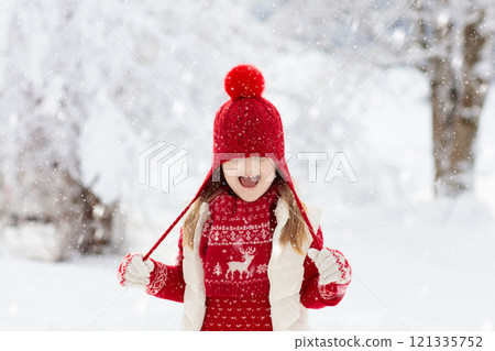 Child playing in snow on Christmas. Kids in winter Child playing in snow on Christmas. Kids in winter 121335752